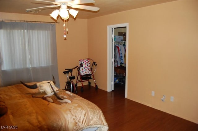 30 Diamond Bar Rd, Pahrump, NV 89048 - bedroom with dark wood-type flooring, a spacious closet, ceiling fan, and baseboards