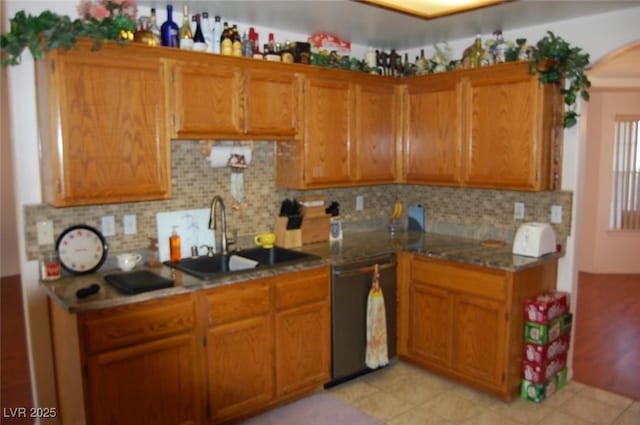 30 Diamond Bar Rd, Pahrump, NV 89048 - kitchen with black dishwasher, a sink, and brown cabinets