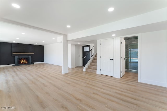 2180 Palora Ave, Las Vegas, NV 89169 - unfurnished living room featuring stairway, light wood-style flooring, a fireplace, baseboards, and recessed lighting