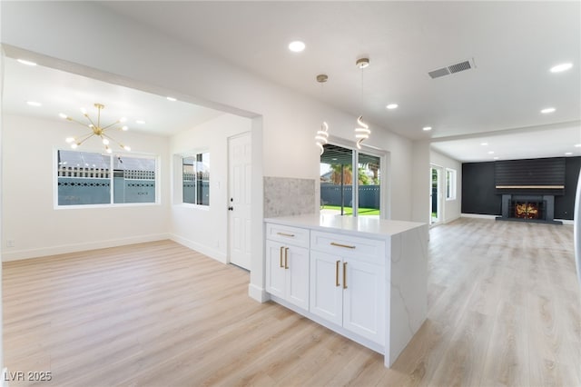 2180 Palora Ave, Las Vegas, NV 89169 - kitchen with open floor plan, light wood finished floors, a chandelier, light countertops, and recessed lighting