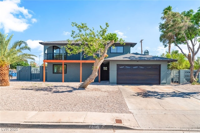 2180 Palora Ave, Las Vegas, NV 89169 - view of front of house featuring concrete driveway, a garage, a gate, a balcony, and stucco siding