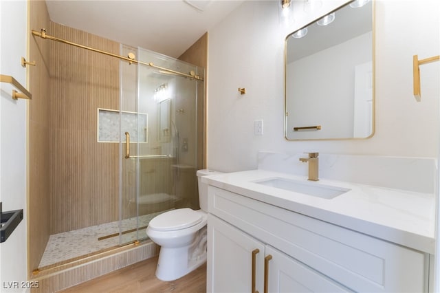 2180 Palora Ave, Las Vegas, NV 89169 - full bathroom with vanity, toilet, a shower stall, and wood finished floors