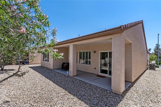 7448 Lintwhite St, North Las Vegas, NV 89084 - rear view of property with stucco siding, a patio, and central air condition unit