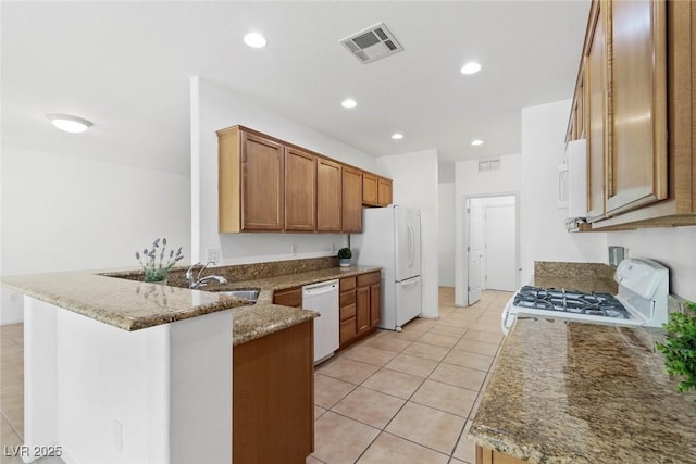 7448 Lintwhite St, North Las Vegas, NV 89084 - kitchen featuring white appliances, a peninsula, a sink, light tile patterned flooring, and recessed lighting