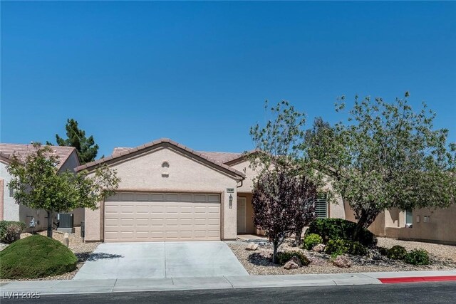 7448 Lintwhite St, North Las Vegas, NV 89084 - view of front facade featuring an attached garage, cooling unit, stucco siding, and driveway