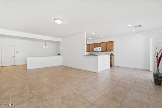 7448 Lintwhite St, North Las Vegas, NV 89084 - unfurnished living room featuring recessed lighting, light tile patterned flooring, and a chandelier