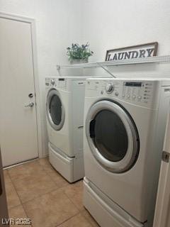 7448 Lintwhite St, North Las Vegas, NV 89084 - laundry area with washing machine and clothes dryer and light tile patterned floors