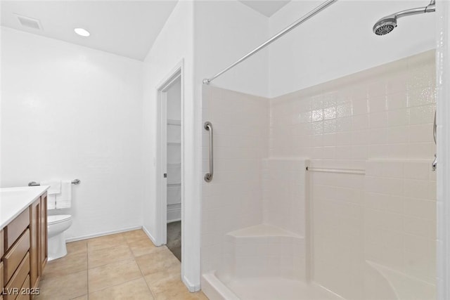 7448 Lintwhite St, North Las Vegas, NV 89084 - bathroom featuring a tile shower, vanity, toilet, a walk in closet, and tile patterned floors