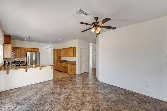 74 Harbor Coast St, Las Vegas, NV 89148 - unfurnished living room with ceiling fan, baseboards, recessed lighting, and a sink