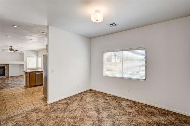 74 Harbor Coast St, Las Vegas, NV 89148 - spare room featuring a ceiling fan, baseboards, light colored carpet, a tiled fireplace, and recessed lighting