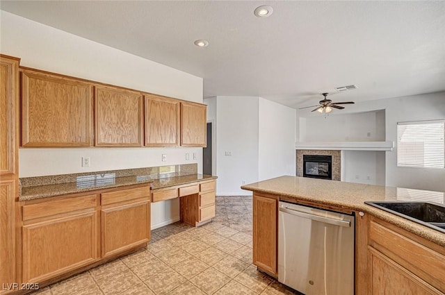 74 Harbor Coast St, Las Vegas, NV 89148 - kitchen featuring stainless steel dishwasher, a ceiling fan, a glass covered fireplace, light tile patterned flooring, and recessed lighting