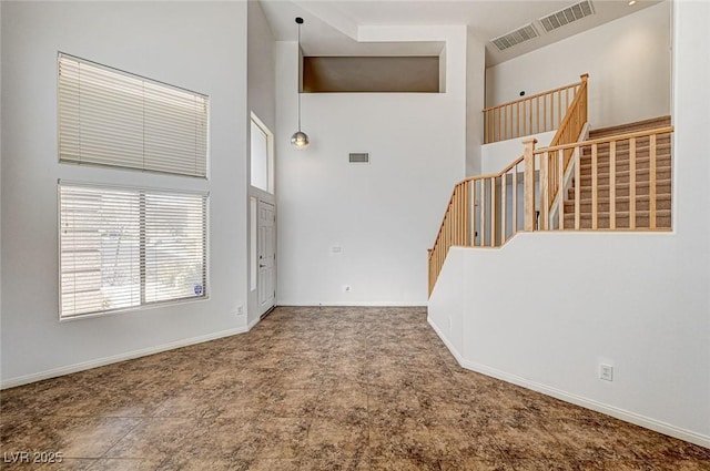 74 Harbor Coast St, Las Vegas, NV 89148 - unfurnished living room with a high ceiling, stairs, and baseboards
