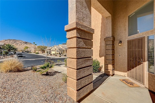 74 Harbor Coast St, Las Vegas, NV 89148 - property entrance with stucco siding, a residential view, and a mountain view
