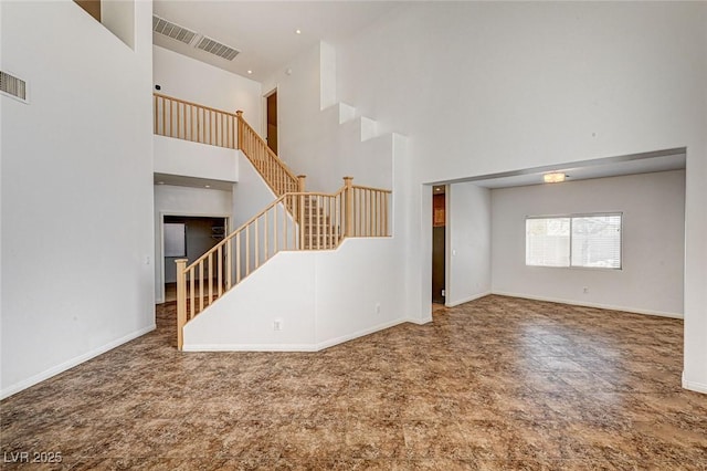74 Harbor Coast St, Las Vegas, NV 89148 - unfurnished living room with a high ceiling, stairway, baseboards, and carpet floors