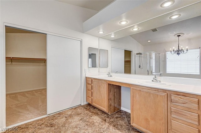 74 Harbor Coast St, Las Vegas, NV 89148 - bathroom featuring a shower stall, double vanity, a spacious closet, a chandelier, and recessed lighting