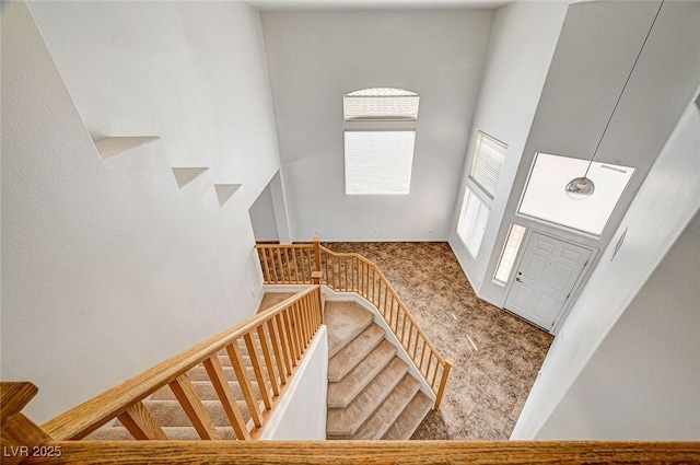 74 Harbor Coast St, Las Vegas, NV 89148 - entryway featuring carpet floors, a high ceiling, healthy amount of natural light, and stairs