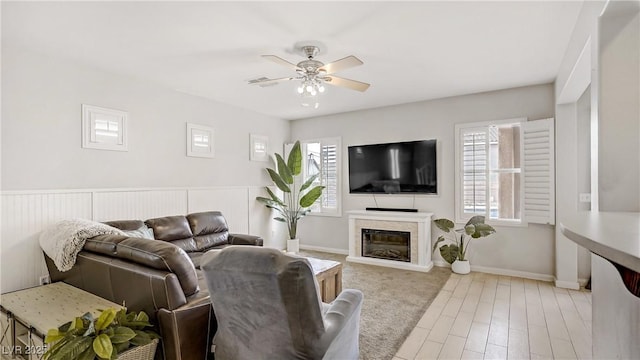 482 Painted Sage Ct, Henderson, NV 89015 - living room featuring ceiling fan, a premium fireplace, wood finished floors, and baseboards