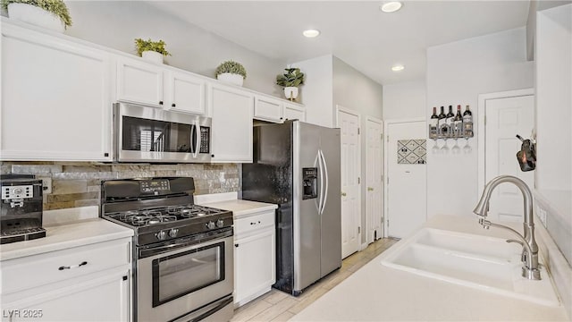 482 Painted Sage Ct, Henderson, NV 89015 - kitchen featuring appliances with stainless steel finishes, a sink, white cabinets, backsplash, and recessed lighting
