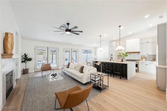 4016 Tyler William Ln, Las Vegas, NV 89130 - living room featuring plenty of natural light, ceiling fan, light wood finished floors, lofted ceiling, and a fireplace