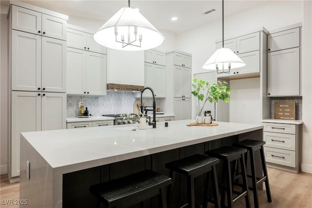 4016 Tyler William Ln, Las Vegas, NV 89130 - kitchen with backsplash, light wood-type flooring, light countertops, and recessed lighting