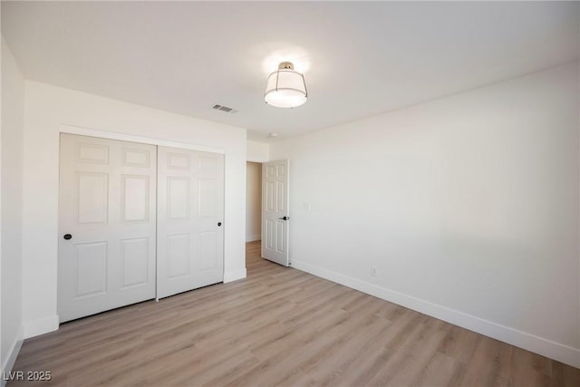 4016 Tyler William Ln, Las Vegas, NV 89130 - unfurnished bedroom with baseboards, light wood-style flooring, and a closet