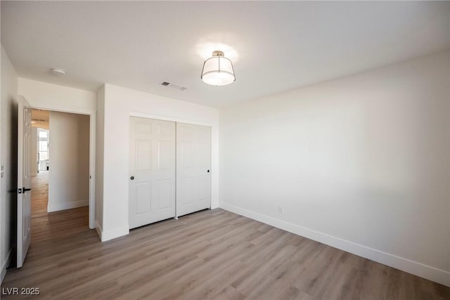 4016 Tyler William Ln, Las Vegas, NV 89130 - unfurnished bedroom featuring wood finished floors, baseboards, and a closet