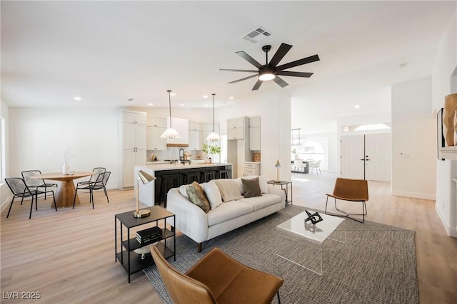 4016 Tyler William Ln, Las Vegas, NV 89130 - living area featuring light wood-type flooring, a ceiling fan, plenty of natural light, and recessed lighting