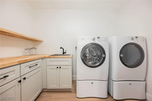 4016 Tyler William Ln, Las Vegas, NV 89130 - laundry area featuring cabinet space, washer and dryer, and light wood finished floors
