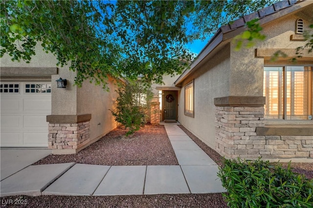 8128 Devils Canyon St, North Las Vegas, NV 89085 - property entrance featuring stucco siding, stone siding, and an attached garage