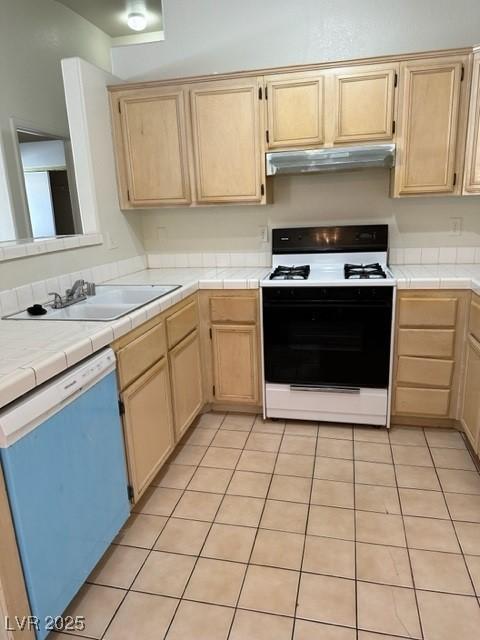 2110 Los Feliz St Unit 2037, Las Vegas, NV 89156 - kitchen with range with gas stovetop, dishwashing machine, under cabinet range hood, and light brown cabinetry
