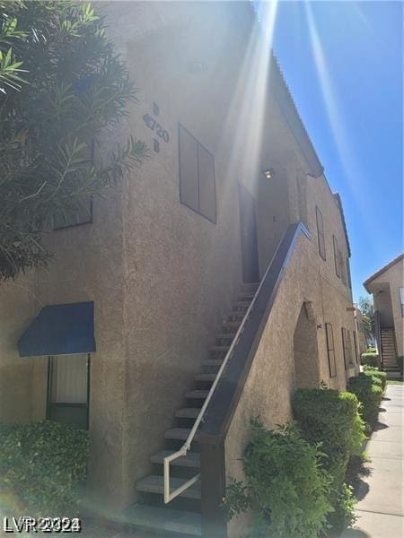 4720 Obannon Dr Unit D, Las Vegas, NV 89102 - view of property exterior with stairway and stucco siding
