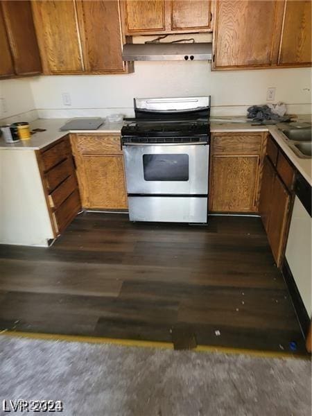 4720 Obannon Dr Unit D, Las Vegas, NV 89102 - kitchen featuring electric range, under cabinet range hood, dark wood-style floors, light countertops, and brown cabinets