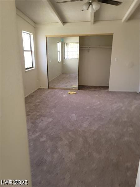 4720 Obannon Dr Unit D, Las Vegas, NV 89102 - unfurnished bedroom with a closet, carpet flooring, ceiling fan, and beam ceiling
