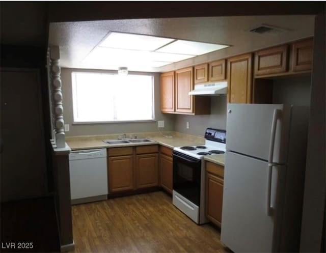 574 Roxella Ln Unit C, Las Vegas, NV 89110 - kitchen with white appliances, under cabinet range hood, a sink, light countertops, and wood finished floors