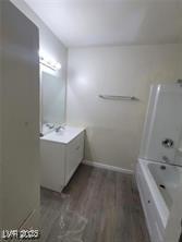 304 Orland St Unit 39, Las Vegas, NV 89107 - full bath featuring vanity, wood finished floors, baseboards, and washtub / shower combination