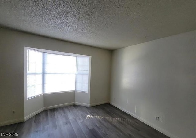 854 Stainglass Ln, Las Vegas, NV 89110 - unfurnished room featuring wood finished floors, baseboards, and a textured ceiling
