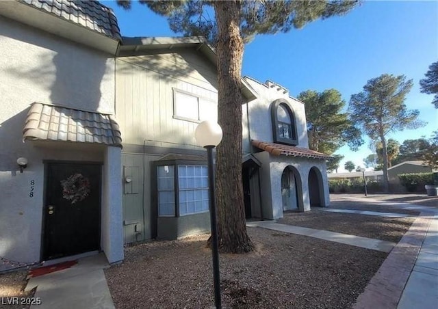 854 Stainglass Ln, Las Vegas, NV 89110 - property entrance with stucco siding and a tiled roof