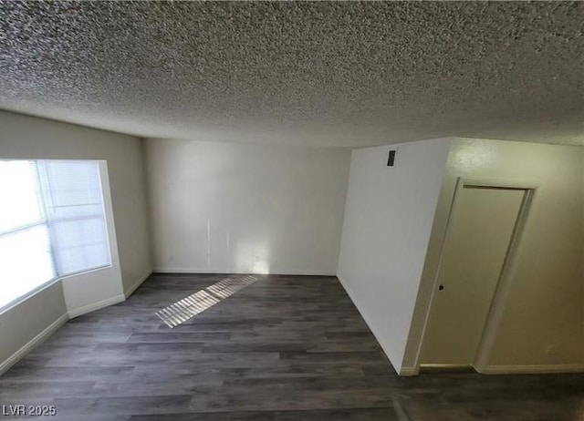 854 Stainglass Ln, Las Vegas, NV 89110 - unfurnished room featuring a textured ceiling, wood finished floors, and baseboards