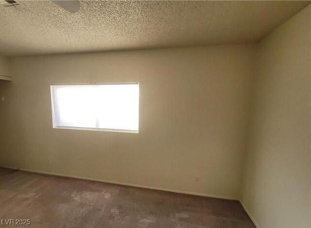 854 Stainglass Ln, Las Vegas, NV 89110 - carpeted empty room with a textured ceiling and baseboards