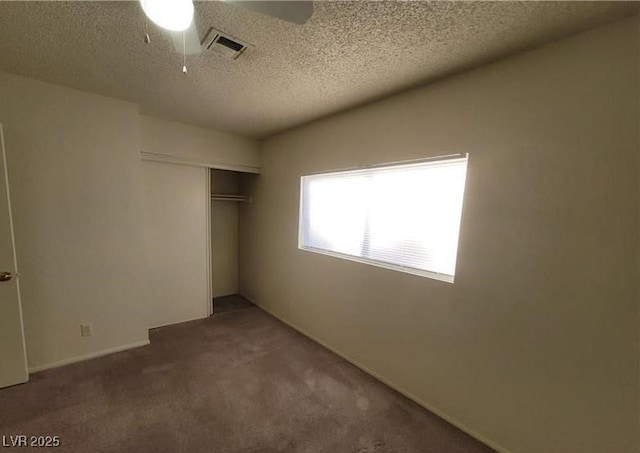 854 Stainglass Ln, Las Vegas, NV 89110 - unfurnished bedroom featuring carpet flooring, a closet, a textured ceiling, and a ceiling fan