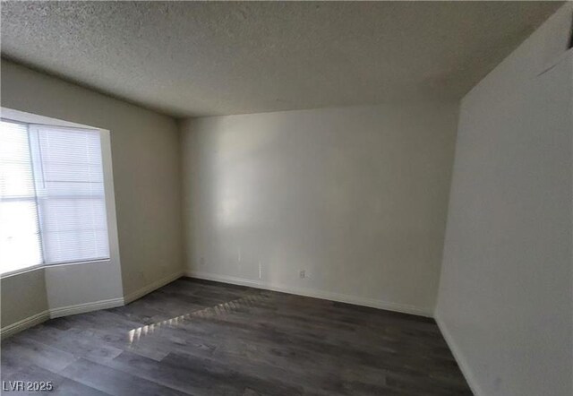 854 Stainglass Ln, Las Vegas, NV 89110 - spare room featuring wood finished floors, a textured ceiling, and baseboards