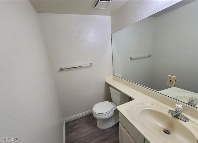 854 Stainglass Ln, Las Vegas, NV 89110 - bathroom featuring vanity, wood finished floors, toilet, and baseboards