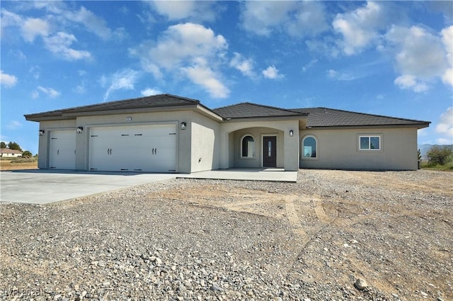 1580 S Tiptop Trl, Pahrump, NV 89048 - view of front of house with concrete driveway, an attached garage, and stucco siding