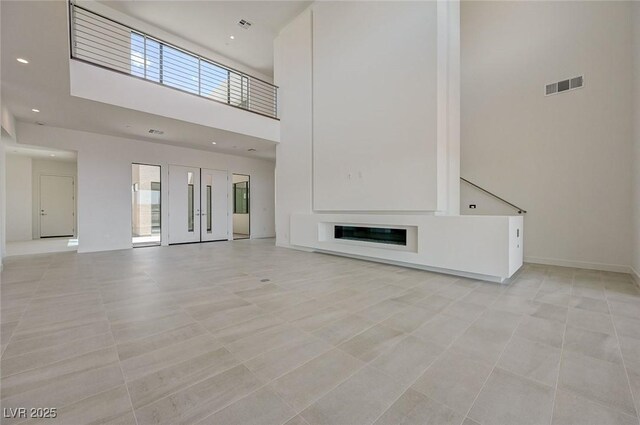 1600 Pleasant Bay Ct, Henderson, NV 89011 - unfurnished living room with a high ceiling, recessed lighting, and light tile patterned flooring