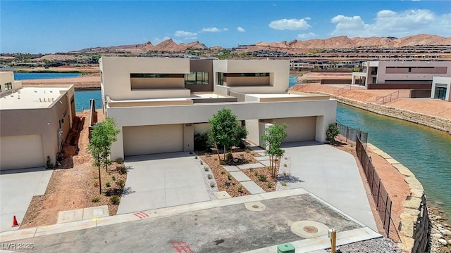1600 Pleasant Bay Ct, Henderson, NV 89011 - view of front of house with stucco siding, a balcony, a water and mountain view, and driveway