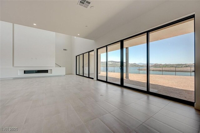 1600 Pleasant Bay Ct, Henderson, NV 89011 - unfurnished living room with a water view, recessed lighting, and a high ceiling