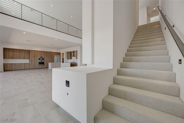 1600 Pleasant Bay Ct, Henderson, NV 89011 - staircase with a high ceiling, recessed lighting, and tile patterned flooring