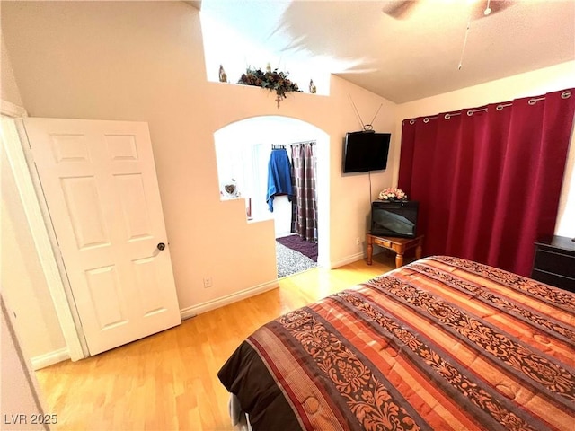 1860 Banaba Ln, Las Vegas, NV 89156 - bedroom with wood finished floors, baseboards, vaulted ceiling, and a ceiling fan