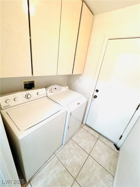 1860 Banaba Ln, Las Vegas, NV 89156 - laundry room featuring independent washer and dryer, cabinet space, and light tile patterned flooring