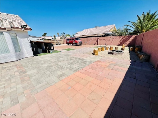 1860 Banaba Ln, Las Vegas, NV 89156 - fenced backyard with a fire pit and a patio area